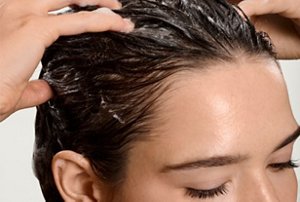Woman massaging conditioner into her hair