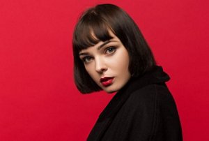 Brunette woman with a choppy blunt cut with a fringe