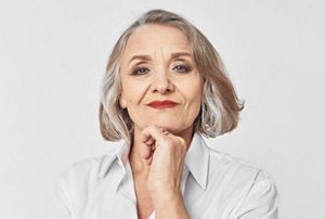 Smiling older woman with thick hair with highlights