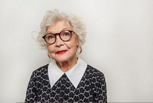 Older woman with a curly pixie cut