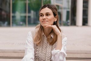 Smiling woman at work with a half up half down hairstyle