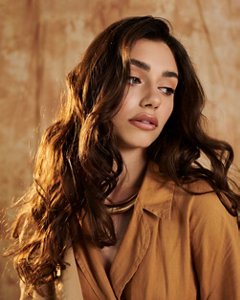Young woman with wavy long dark brown hair