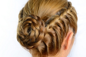 Dark blonde woman with a braided bun updo