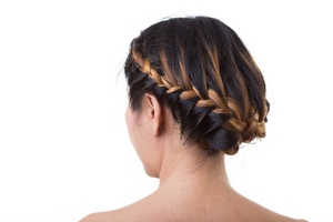 Brunette woman with caramel highlights with a French braid updo