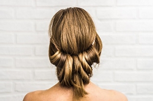 Dark blonde woman wearing a low updo wedding hairstyle