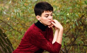 Young brunette woman with a classic, short pixie cut