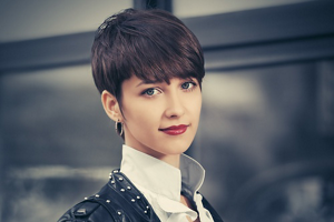 Beautiful brunette woman with a short, stylish classic pixie cut