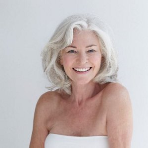 smiling woman with voluminous grey hair