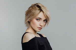 Woman with a styled bixie cut with a side parting