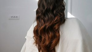 Red and copper highlights on long black hair