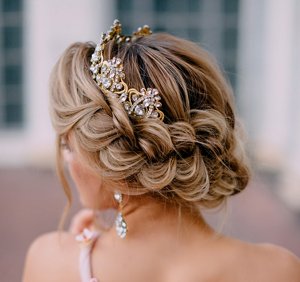 Bridesmaid with braided crown hairstyle styled with plaits