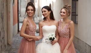 Elegant bride with her two bridesmaids in pink dresses