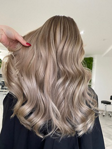 Woman with long, ash blonde hair with bronde highlights