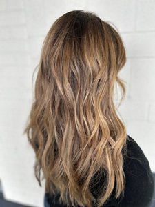 Woman with long balayaged hair with face-framing layers