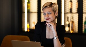 Professional young woman with a classic blonde bixie haircut with dark roots