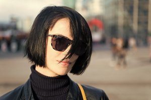 Woman with black hair with a French bob hairstyle with a side parting