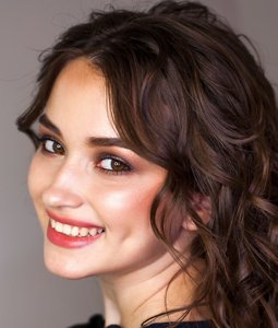 Woman with naturally-curly hair with curtain bangs