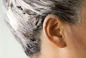 Woman applying a deep conditioning treatment after using a box dye