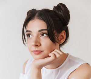 Young woman with her hair tied up in a double bun style