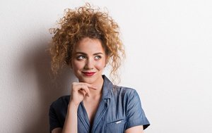 Young woman with naturally curly hair styled in a curly pineapple updo