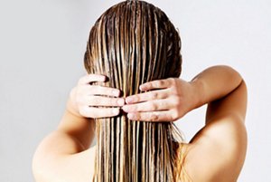 Blonde woman conditioning her hair