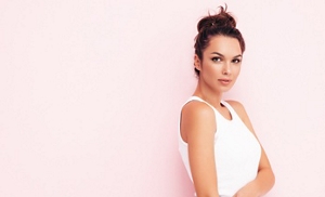 Brunette woman with her hair tied up in a loose, messy bun