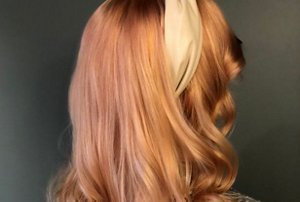 Woman with light red hair with rich caramel highlights