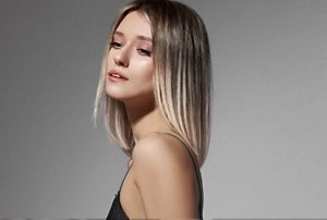 Blonde woman with a mid-length bob with ashy, beigey highlights