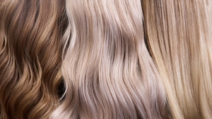 Three women with different shades of toned blonde hair