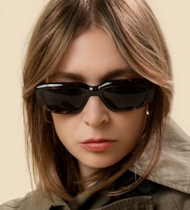 Woman wearing sunglasses with a layered curtain fringe