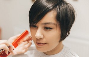 Woman with a pixie cut with light, feathered layers