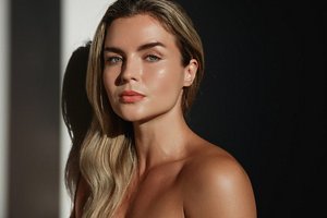 Woman with long layered haircut with soft face framing strands