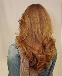 Natural redhead with a haircut with waterfall layers
