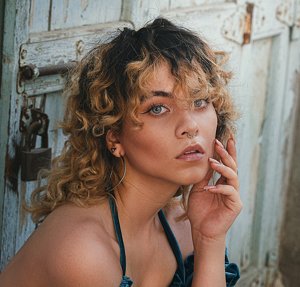 Woman wearing geometric earrings with a mullet-inspired haircut