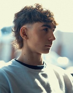 Man in his 20s with a shaped and textured mullet haircut