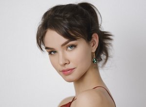 Woman with her hair in a ponytail with short, styled curtain bangs