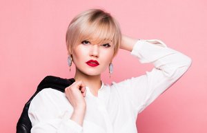 Woman with fine, blonde hair with a sleek bixie haircut