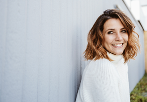 Smiling woman with textured mid-length layered haircut