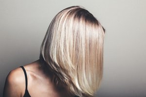 Blonde woman with an angled, layered mid-length bob