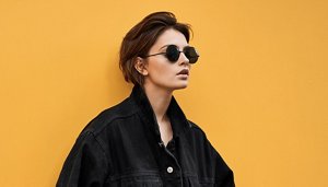 Woman wearing sunglasses with a short, modern bixie cut