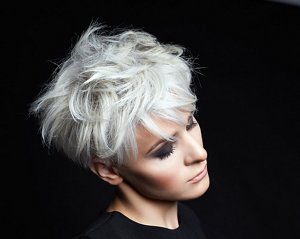 Blonde lady with a tousled and textured bixie haircut
