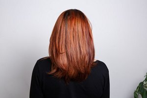 Redheaded woman with elegant long layered hairstyle with smooth, styled ends