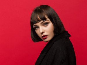 Woman with a dark brunette blunt cut with a fringe