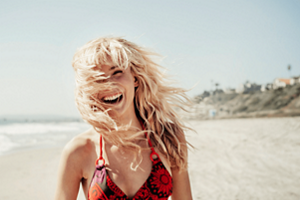 Woman with bleached hair wearing a red and black bikini
