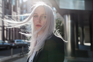 Woman with ash blonde hair with dark roots