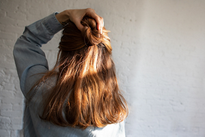 Woman with gingerbread caramel hair in a top-knot