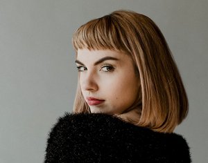 Professional woman with a blunt-cut long bob with a fringe