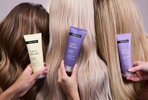 Three models posing with John Frieda toners