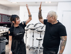Hair stylists doing high five in a salon