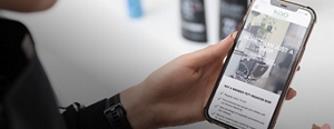 Kao Pro Shop open on a smartphone, held in the hand of a stylist